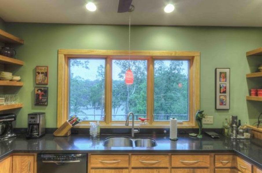 delightful kitchen counter with window for a view to the outside; wood trim