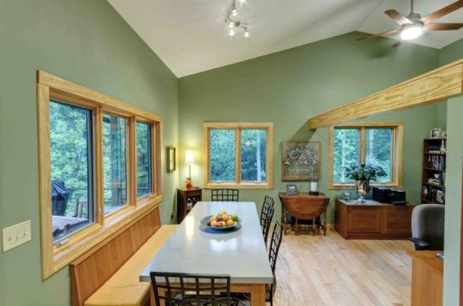 dining room with pew long bench and chairs, large laminated beam