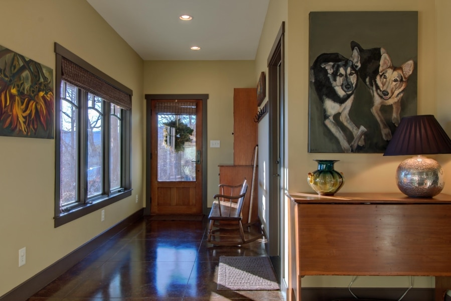 owner entry with stained concrete floors absorbing passive solar heat energy during the winter; portrait of beloved pups who helped us build the home