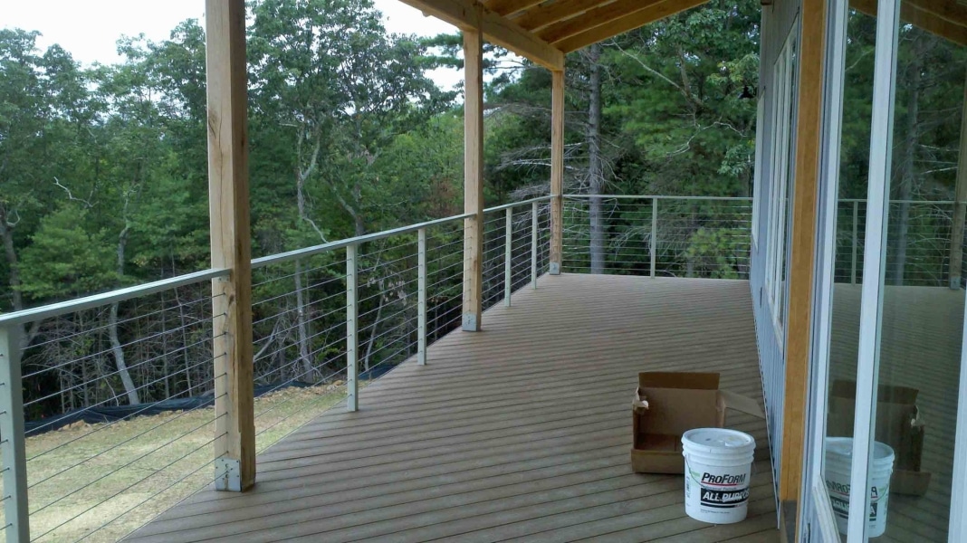 image of an open stainless steel cable railing system between white oak timber posts by Timber Ridge Craftsmen Inc near Smith Mountain Lake VA